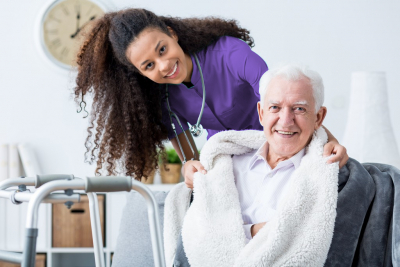 smiling african caregiver with her patient