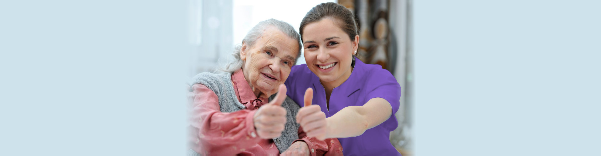 senior woman and female caregiver doing thumbs up