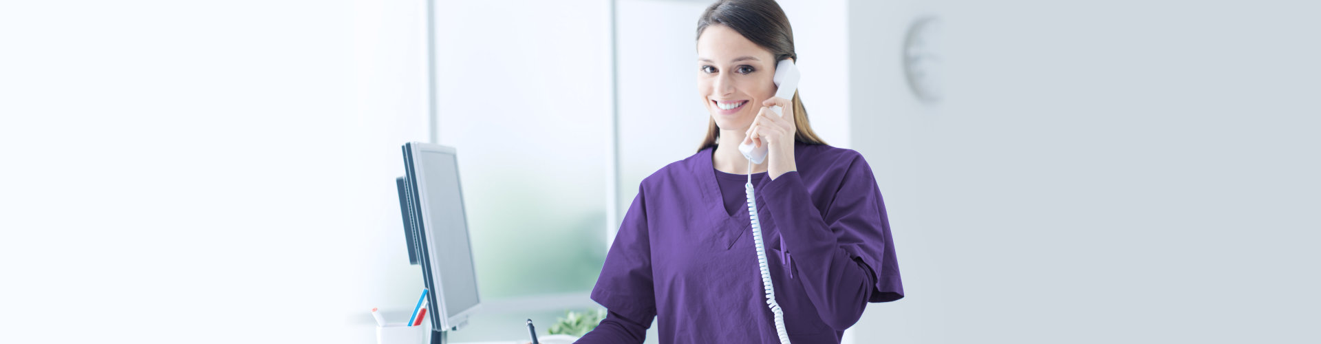 caregiver holding a telephone