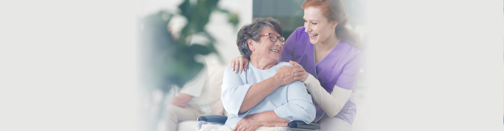 caregiver and senior lady smiling